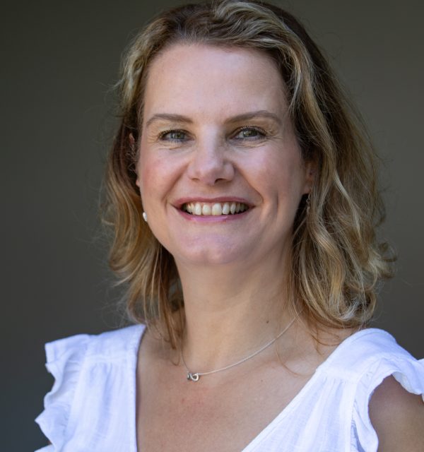 Woman, wearing a white blouse.